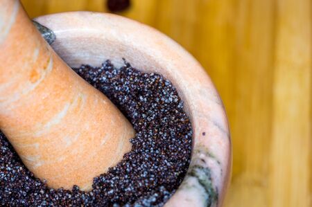 handmade preparation of treats for traditional Orthodox Christmas - mortar with poppy seeds, dried...