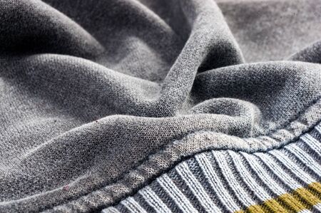 clothing items washed cotton fabric texture with seams, clasps, buttons and rivets, macro, close-up