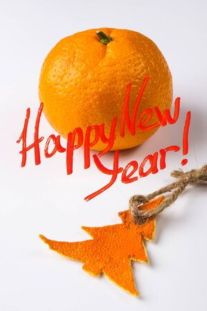 New Year Concept postcard. Christmas decorations hand made from tangerine peel and fir-tree branches with a congratulatory inscriptionの写真素材