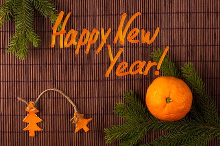 New Year Concept postcard. Christmas decorations hand made from tangerine peel and fir-tree branches with a congratulatory inscriptionの写真素材