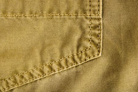clothing items washed cotton fabric texture with seams, clasps, buttons and rivets, macro, close-up