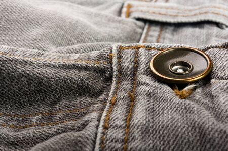 clothing items washed cotton fabric texture with seams, clasps, buttons and rivets, macro, close-upの写真素材