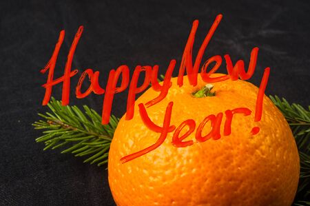 New Year Concept postcard. Christmas decorations hand made from tangerine peel and fir-tree branches with a congratulatory inscriptionの写真素材