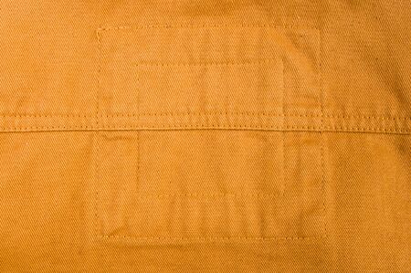 clothing items washed cotton fabric texture with seams, clasps, buttons and rivets, macro, close-up