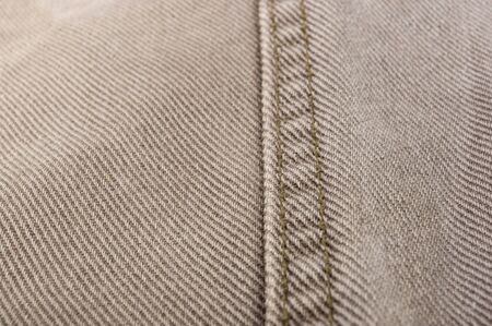 clothing items washed cotton fabric texture with seams, clasps, buttons and rivets, macro, close-up