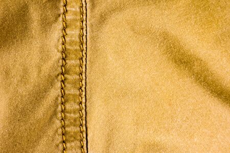 clothing items stonewashed cotton fabric texture with seams, clasps, buttons and rivets, macro