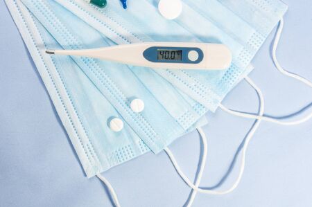 Background for news about the novel coronavirus COVID-19 - protective medical masks and thermometer. Chinese coronavirus outbreak, Middle East respiratory syndrome coronavirus.の写真素材