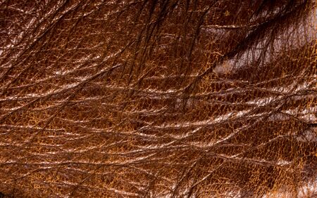 Old vintage genuine soft brown leather texture background, top layer with pores and scratches, macroの写真素材