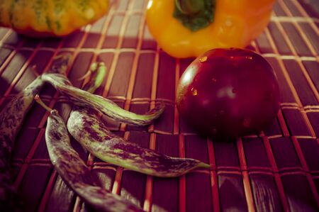 Still life - small spotted squash, asparagus beans, purple Basil, paprika, yellow and chocolate tomatoes on bamboo Matの写真素材