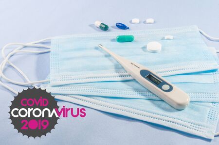 Background for news about the novel coronavirus COVID-19 - protective medical masks, thermometer and text Coronavirus COVID-19. Chinese coronavirus outbreak, Middle East respiratory syndrome coronavirus.の写真素材