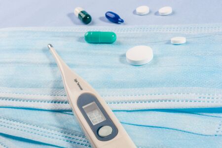 Background for news about the novel coronavirus COVID-19 - protective medical masks, thermometer and text Coronavirus COVID-19. Chinese coronavirus outbreak, Middle East respiratory syndrome coronavirus.の写真素材