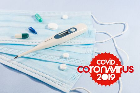 Background for news about the novel coronavirus COVID-19 - protective medical masks, thermometer and text Coronavirus COVID-19. Chinese coronavirus outbreak, Middle East respiratory syndrome coronavirus.の写真素材