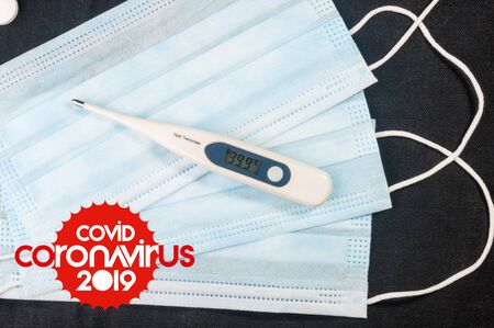 Background for news about the novel coronavirus COVID-19 - protective medical masks, thermometer and text Coronavirus COVID-19. Chinese coronavirus outbreak, Middle East respiratory syndrome coronavirus.の写真素材