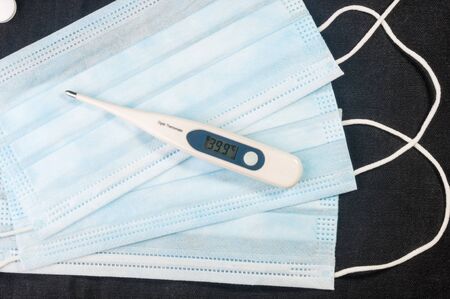 Background for news about the novel coronavirus COVID-19 - protective medical masks, thermometer and text Coronavirus COVID-19. Chinese coronavirus outbreak, Middle East respiratory syndrome coronavirus.の写真素材