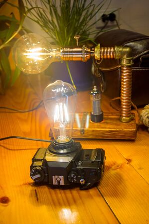 Light fixtures handmade in vintage style, retro film SLR camera case and wooden case, led lampsの写真素材