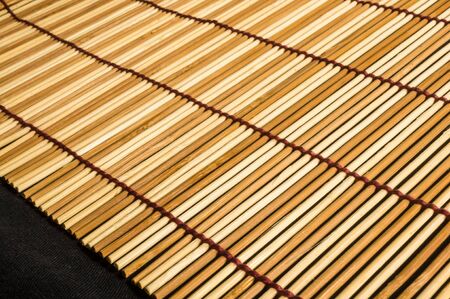 brown bamboo Mat - stand food, close-up, macro, black backgroundの写真素材