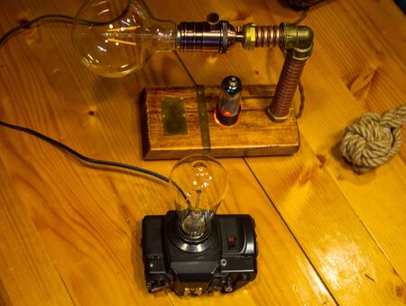 Light fixtures handmade in vintage style, retro film SLR camera case and wooden case, led lampsの写真素材