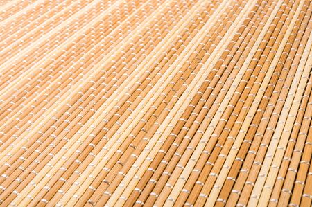 brown bamboo Mat - stand food, close-up, macro, black backgroundの写真素材