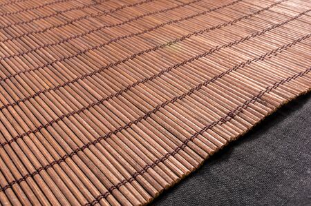 brown bamboo Mat - stand food, close-up, macro, black backgroundの写真素材