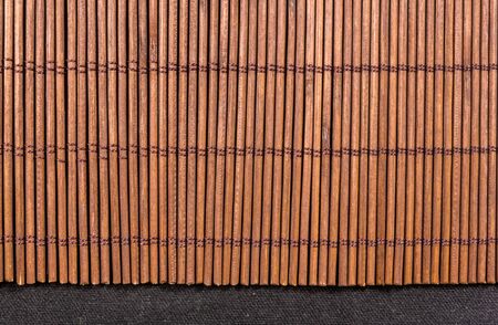 brown bamboo Mat - stand food, close-up, macro, black backgroundの写真素材