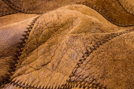 Old vintage genuine soft brown leather texture background, top layer with pores and scratches, macroの写真素材