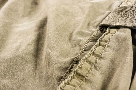clothing items washed cotton fabric texture with seams, clasps, buttons and rivets, macro, close-upの写真素材