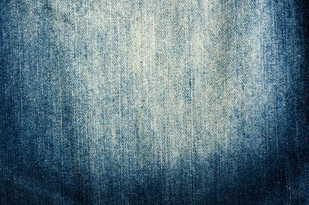clothing items blue washed faded jeans cotton fabric texture with seams, clasps, buttons and rivets, macroの写真素材