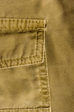 clothing items washed cotton fabric texture with seams, clasps, buttons and rivets, macro, close-upの写真素材