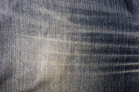 clothing items blue washed faded jeans cotton fabric texture with seams, clasps, buttons and rivets, macroの写真素材