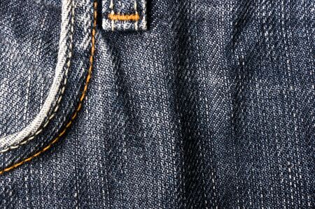 clothing items blue washed faded jeans cotton fabric texture with seams, clasps, buttons and rivets, macroの写真素材