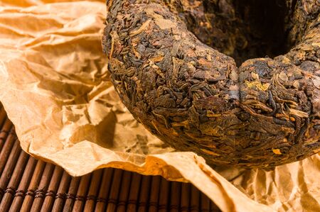 Chinese pressed puer tea on wrapping paper, close up, macroの写真素材