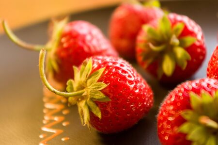 fresh ripe berries strawberries on black ceramic plateの写真素材