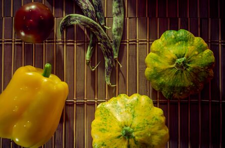 Still life - small spotted squash, asparagus beans, purple Basil, paprika on bamboo Matの写真素材