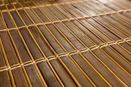 brown bamboo Mat - stand food, close-up, macro, wooden backgroundの写真素材