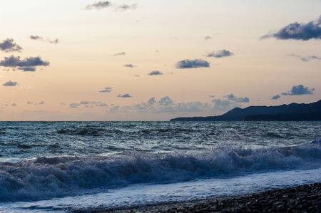 Summer sea sunset, the sun, waves and clouds, beautiful dramatic lightingの写真素材