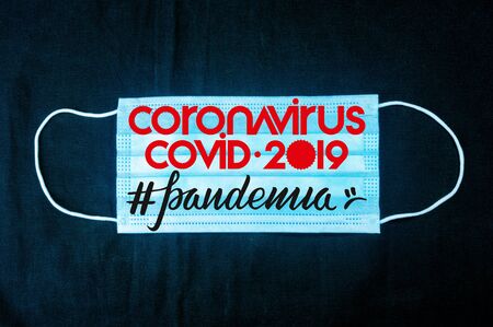 Background for news about the novel coronavirus COVID-19 - protective medical masks, thermometer and text Coronavirus COVID-19, lettering tag pandemia.の写真素材