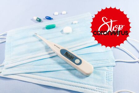 Background for news about the novel coronavirus COVID-19 - protective medical masks, thermometer and text Coronavirus COVID-19.の写真素材