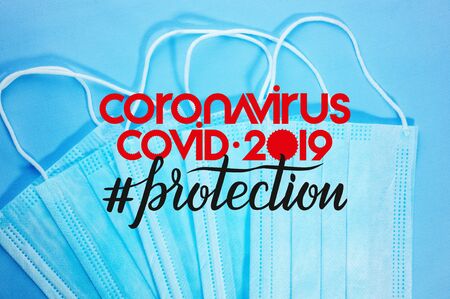 Background for news about the novel coronavirus COVID-19 - protective medical masks, thermometer and text Coronavirus COVID-19, lettering tag protection.の写真素材