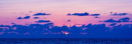 Summer sea sunset, the sun, waves and clouds, beautiful dramatic lightingの写真素材