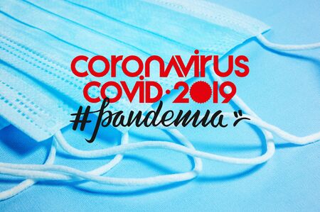 Background for news about the novel coronavirus COVID-19 - protective medical masks, thermometer and text Coronavirus COVID-19, lettering tag pandemia. Coronavirus outbreak, Middle East respiratory syndrome coronavirus.の写真素材