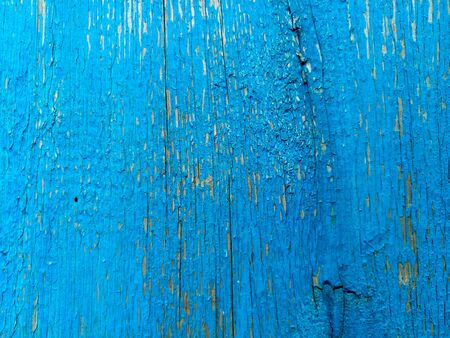 texture of old painted shabby rustic wooden fence made of planks, with rusty nails, close-up, grunge backgroundの写真素材