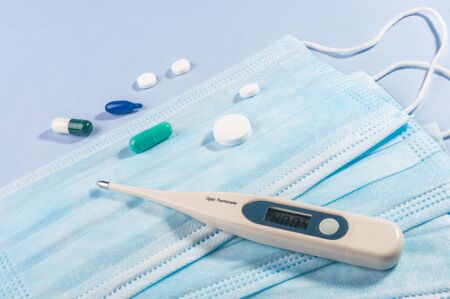 Background for news about the novel coronavirus COVID-19 - protective medical masks and thermometer. Chinese coronavirus outbreak, Middle East respiratory syndrome coronavirus.の写真素材