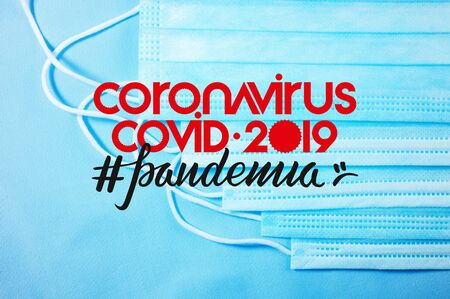 Background for news about the novel coronavirus COVID-19 - protective medical masks, thermometer and text Coronavirus COVID-19, lettering tag pandemia. Chinese coronavirus outbreak, Middle East respiratory syndrome coronavirus.の写真素材