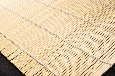 brown bamboo Mat - stand food, close-up, macro, black backgroundの写真素材