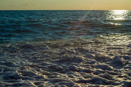 Summer sea sunset, the sun, waves and clouds, beautiful dramatic lightingの写真素材