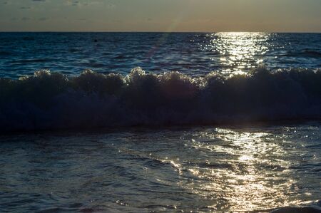 Summer sea sunset, the sun, waves and clouds, beautiful dramatic lightingの写真素材