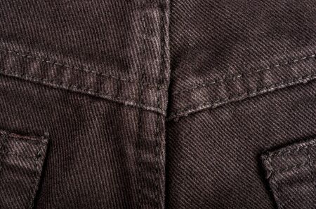 clothing items washed cotton fabric texture with seams, clasps, buttons and rivets, macro, close-upの写真素材