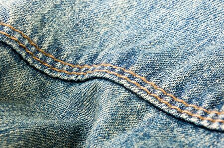 clothing items blue washed faded jeans cotton fabric texture with seams, clasps, buttons and rivets, macroの写真素材