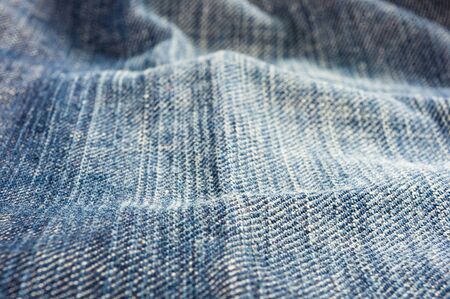 clothing items blue washed faded jeans cotton fabric texture with seams, clasps, buttons and rivets, macroの写真素材