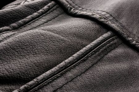 Old vintage genuine soft black leather texture background, top layer with pores and scratches, macroの写真素材